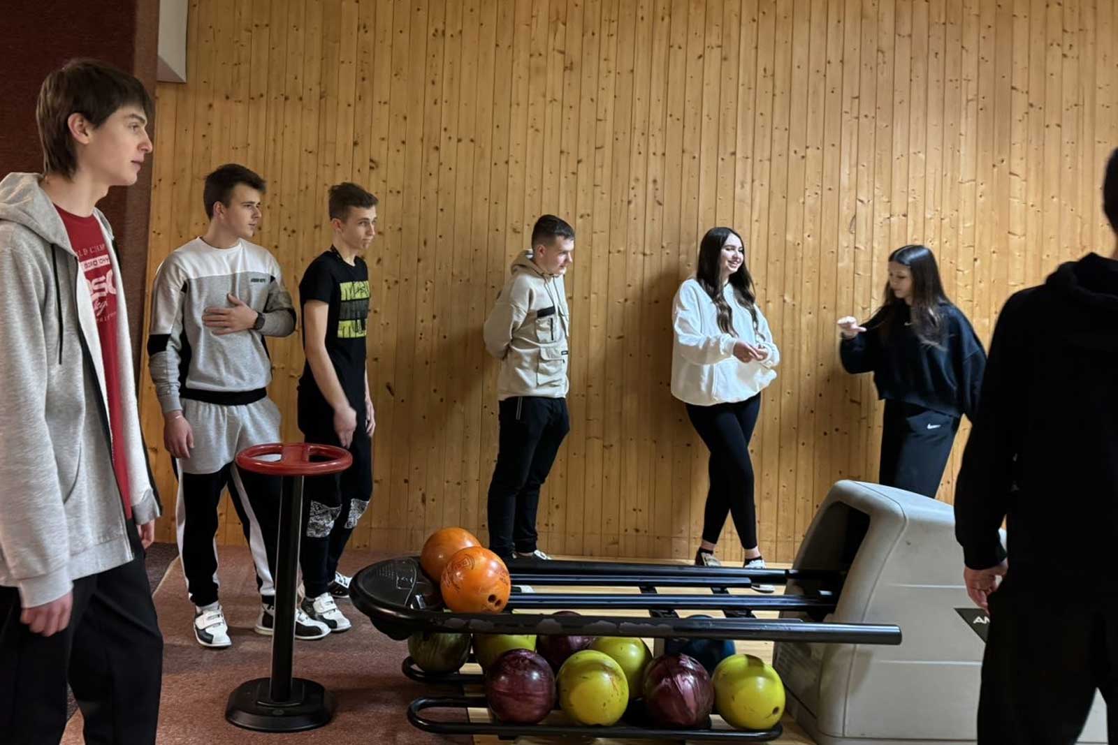 A group of teenagers and young adults at the local bowling alley